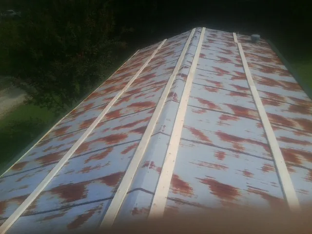 Rusted metal roof panels with new wood purlins before replacement — Storm Damage Roof Repair in Oconomowoc by Roofing Brothers