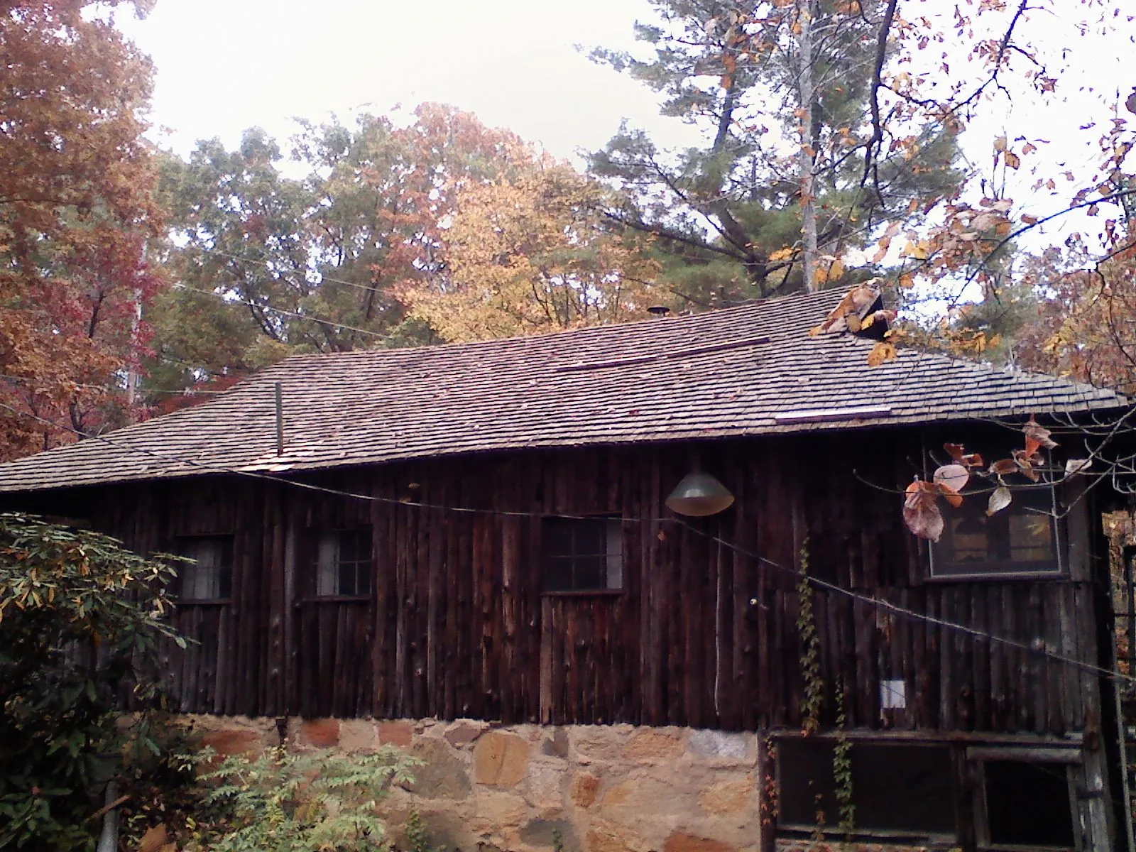 Weathered wood shake roof on a rustic board sided cabin in Oconomowoc